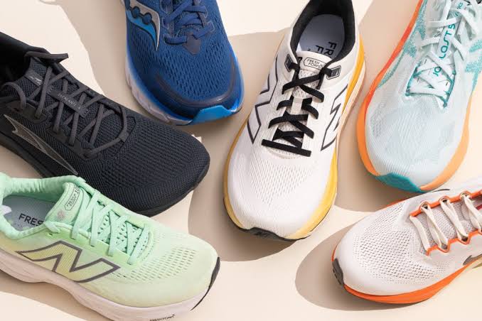 Collection of modern men's running shoes in different colors arranged together on a light background